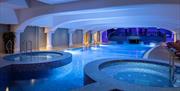 The soothing jacuzzis and saltwater pool, bathed in blue light