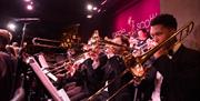 Young musicians play trombones on a stage