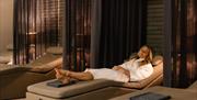 A visitor relaxes on one of the day beds in the spa at Hoar Cross Hall