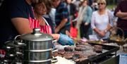 Stall holder cooking burgers at Tamworth Food Gusto Festival