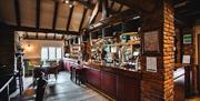 Image shows the bar of The Moat House's lounge bar, ready for service