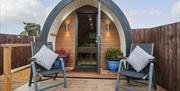 Outside The Pod at Bank House Farm - a glamping pod with two deckchairs outside for soaking up the sun