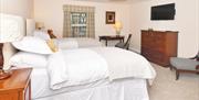 The bed, TV, and furnishings in Room 3 at The Royal Oak