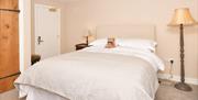 Room 4 at The Royal Oak, with bed, furnishings, and a teddy bear nestled up against the pillows