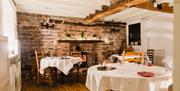 Tables with white tablecloths, ready for service