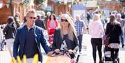 Couple pushing a pushchair at Trentham Shopping Village