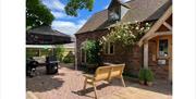 Outdoor courtyard at Perrys Field to Fork with seating and BBQs.
