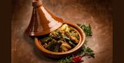 Tagine-style chicken and vegetables in a clay pot