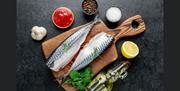 Fresh fish fillets with herbs, lemon and olive oil