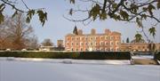 The house at Weston Park surrounded by snowy landscape