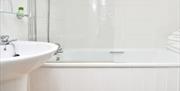 The bathroom in Room 1 of The Fountain Inn, showing the sink, shower and bath
