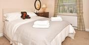 The bed in Room 3 at The Fountain Inn, with teddy and towels
