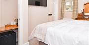 Bedroom with plasma screen TV, fridge and tea & coffee making facilities