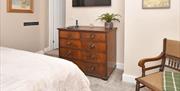 Image of bedroom, showing bed, furnishings and wall-mounted TV