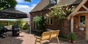 Outdoor courtyard at Perrys Field to Fork with seating and BBQs.