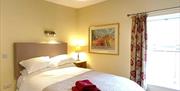 One of the bedrooms at The Victoria in Newcastle-under-Lyme, Staffordshire. Image shows the bed and furnishings.