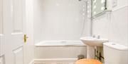 One of the bathrooms at The Victoria in Newcastle-under-Lyme, Staffordshire. Image shows the bath/shower, sink and toilet.