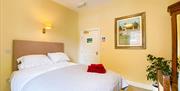 Room 2 at The Victoria in Newcastle-under-Lyme, Staffordshire. Image shows the bed and furnishings.
