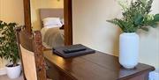 One of the bedrooms at The Victoria in Newcastle-under-Lyme, Staffordshire. Image shows a desk and mirror.