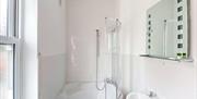 One of the bathrooms at The Victoria in Newcastle-under-Lyme, Staffordshire. Image shows the sink and bath/shower.