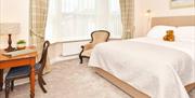 One of the bedrooms at The Victoria in Newcastle-under-Lyme, Staffordshire. Image shows the bed and furnishings.