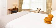 One of the bedrooms at The Victoria in Newcastle-under-Lyme, Staffordshire. Image shows the bed and furnishings.