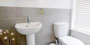 One of the bathrooms at The Victoria in Newcastle-under-Lyme, Staffordshire. Image shows the sink and toilet.