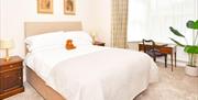 One of the bedrooms at The Victoria in Newcastle-under-Lyme, Staffordshire. Image shows the bed and furnishings.