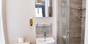 A bathroom with toilet, sink and shower