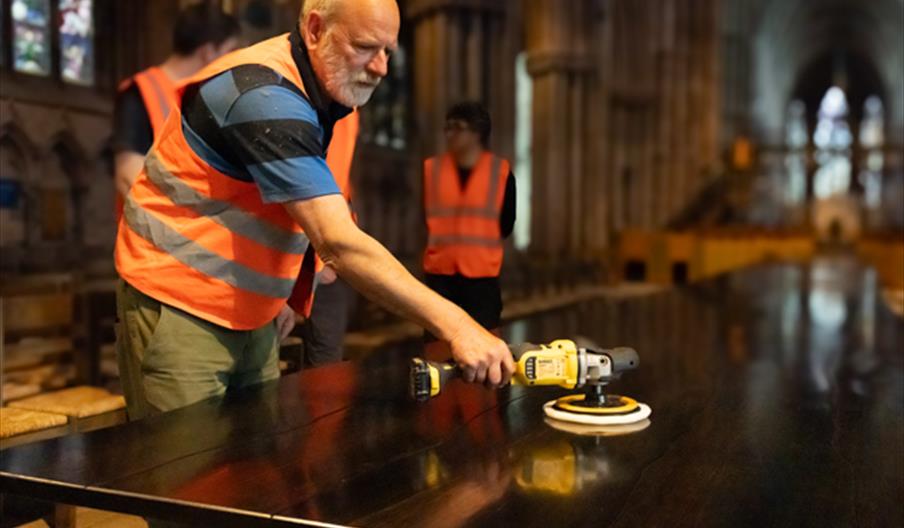 Creator of the Fenland black oak 'Table for the Nation', Hamish Low polishing the table at Lichfield Cathedral Creator of the Fenland black oak 'Table for the Nation', Hamish Low polishing the table at Lichfield Cathedral