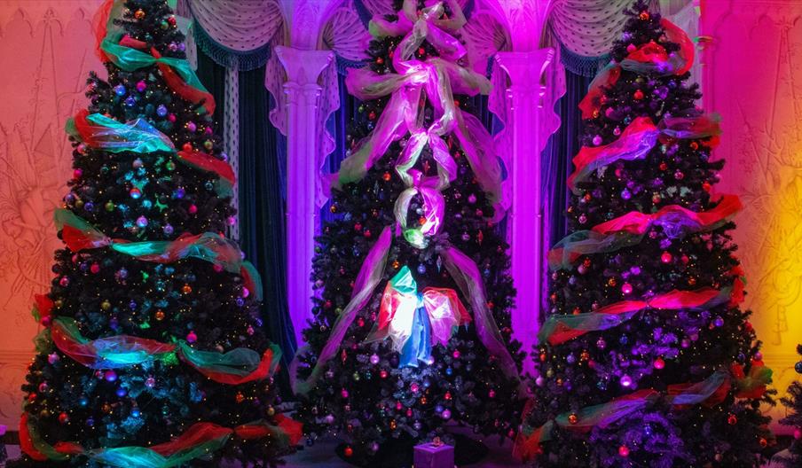 Three ornately decorated Christmas trees with presents Three ornately decorated Christmas trees with presents